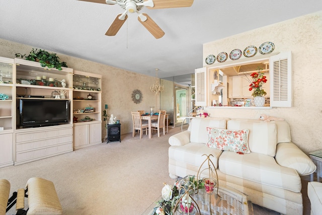 carpeted living room with ceiling fan