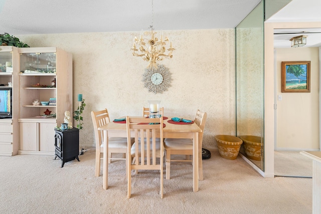 dining room with carpet flooring and a chandelier