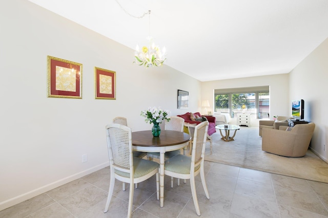 dining area featuring light tile patterned floors and a notable chandelier