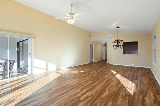 interior space featuring ceiling fan with notable chandelier, lofted ceiling, and hardwood / wood-style floors