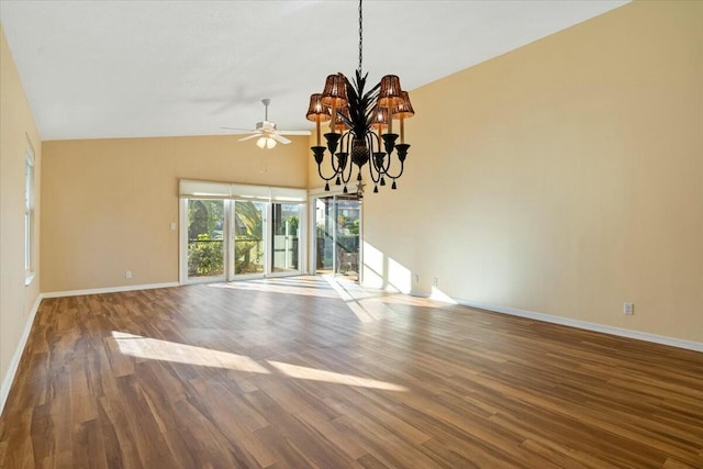 empty room featuring ceiling fan with notable chandelier, lofted ceiling, and hardwood / wood-style floors