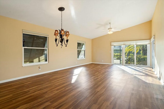 empty room with wood-type flooring, lofted ceiling, and ceiling fan with notable chandelier