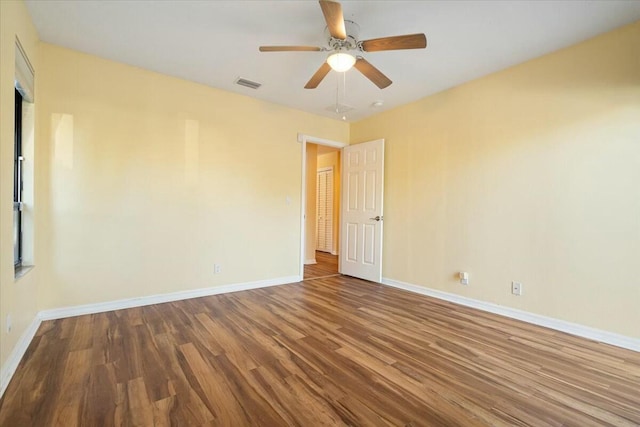 empty room featuring ceiling fan and hardwood / wood-style floors