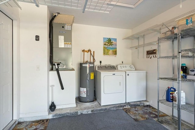 laundry area with water heater and washer and dryer