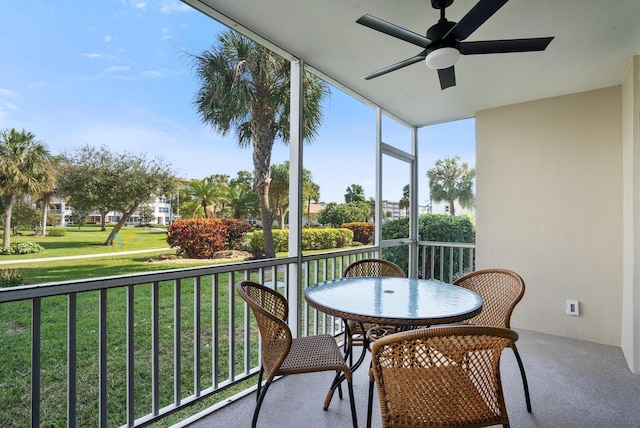 sunroom / solarium featuring ceiling fan