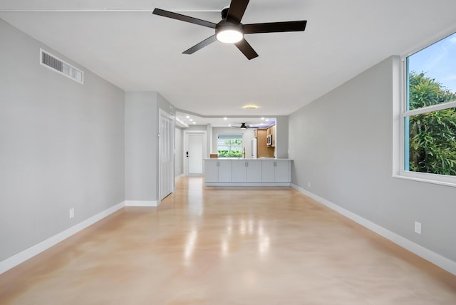 unfurnished living room featuring ceiling fan