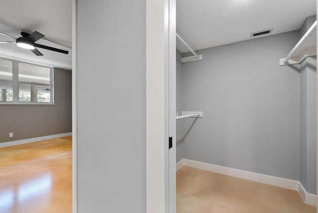 walk in closet with ceiling fan