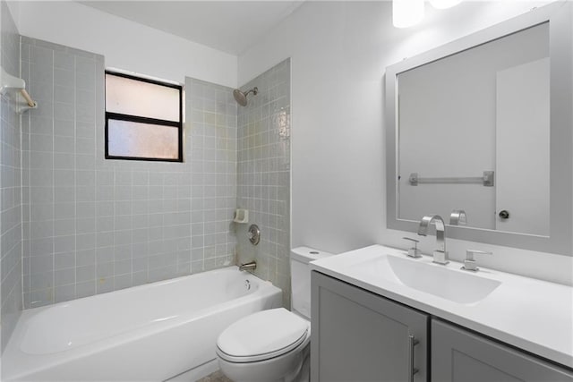 full bathroom with tiled shower / bath combo, vanity, and toilet