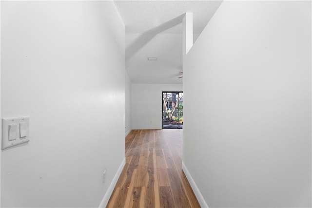 corridor with hardwood / wood-style flooring