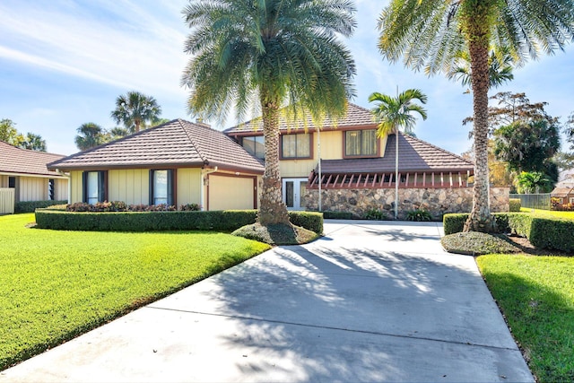 view of front of property with a garage and a front lawn