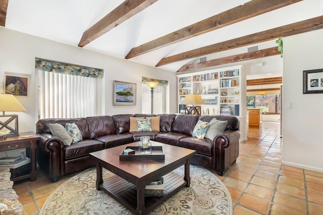 tiled living room with lofted ceiling with beams and a healthy amount of sunlight