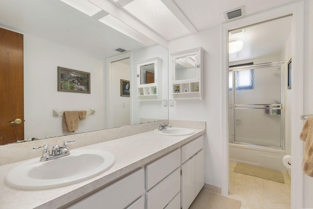 bathroom with vanity, tile patterned floors, and enclosed tub / shower combo