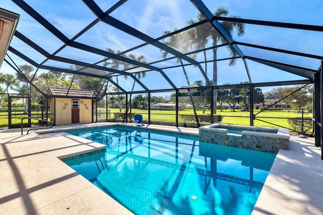 view of pool featuring an in ground hot tub, glass enclosure, and a patio