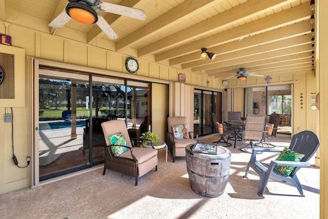 view of patio with ceiling fan and a fire pit