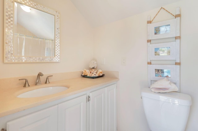 bathroom featuring lofted ceiling, vanity, curtained shower, and toilet