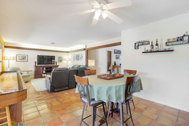 dining space with ceiling fan and tile patterned flooring