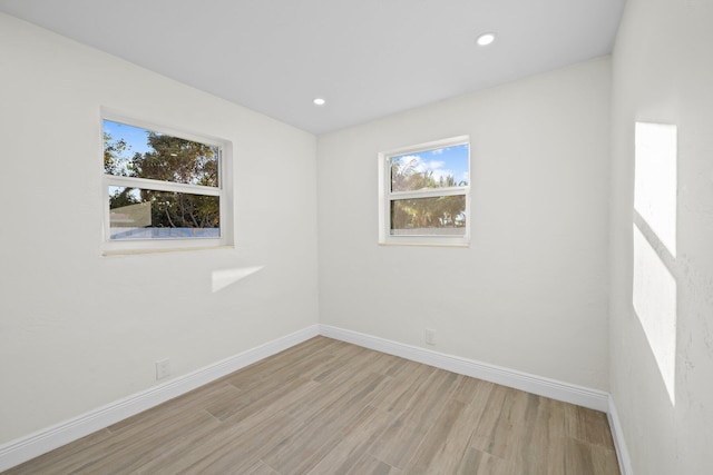 unfurnished room with light hardwood / wood-style floors