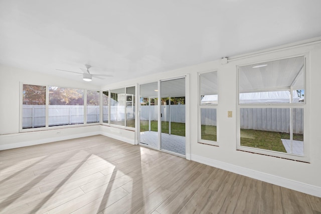 unfurnished sunroom with ceiling fan and a healthy amount of sunlight