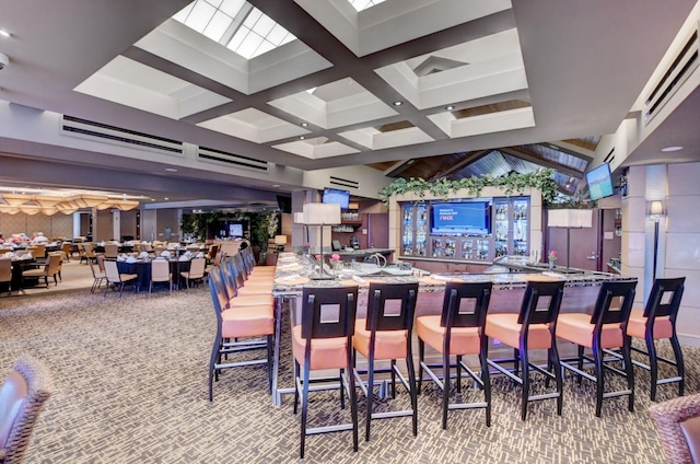 interior space featuring coffered ceiling and beam ceiling