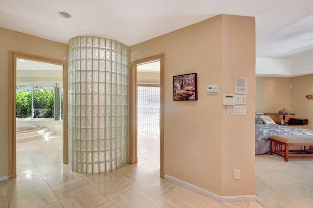 hall featuring light tile patterned flooring