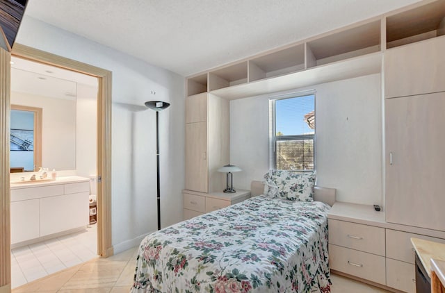 tiled bedroom featuring connected bathroom and a textured ceiling