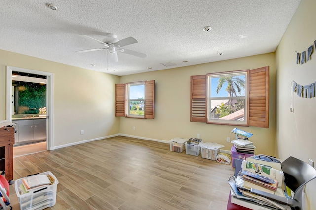 misc room with a textured ceiling and ceiling fan