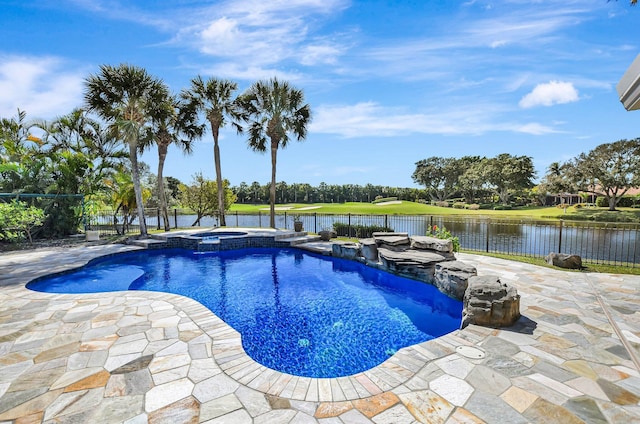 view of swimming pool with a patio area, a water view, and an in ground hot tub