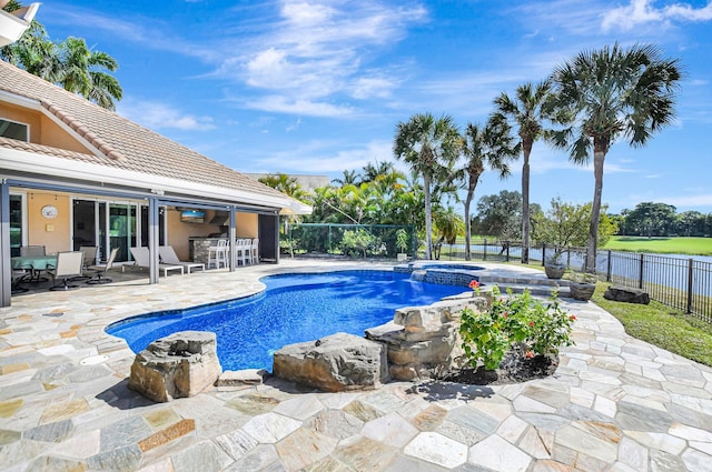 view of swimming pool featuring an in ground hot tub, exterior bar, and a patio area