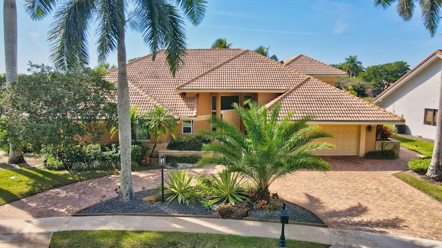 mediterranean / spanish-style home with a garage