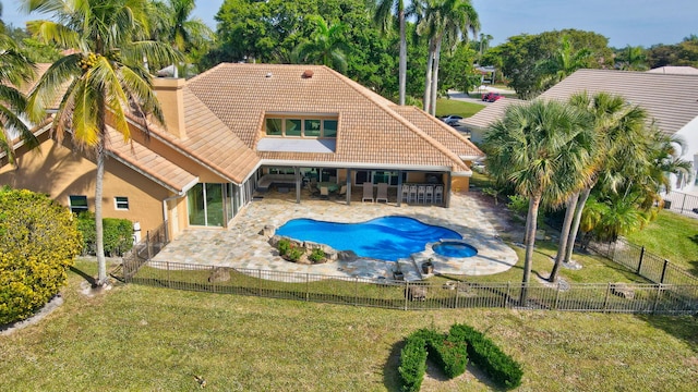 view of swimming pool featuring a bar, a yard, a patio, and an in ground hot tub