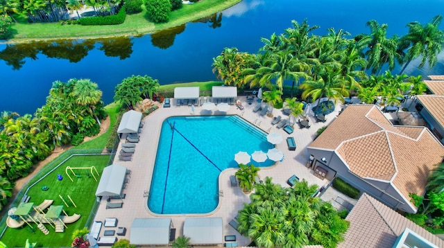 view of swimming pool with a water view and a patio area