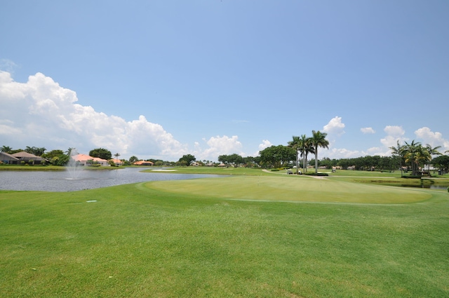 view of property's community featuring a water view and a yard