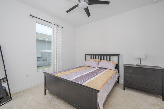 carpeted bedroom with a ceiling fan and baseboards