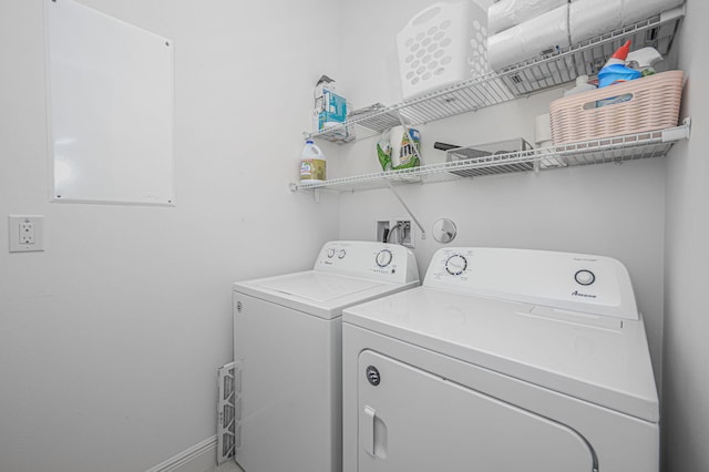 laundry area featuring washer and dryer, laundry area, and baseboards