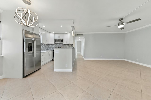 kitchen featuring stainless steel appliances, decorative backsplash, white cabinets, light tile patterned flooring, and decorative light fixtures