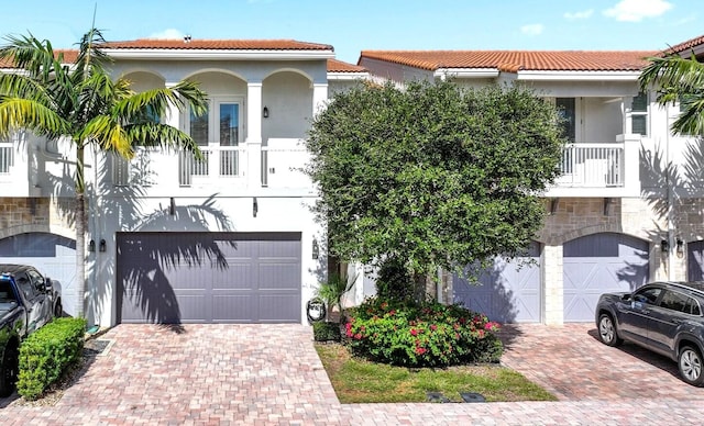 mediterranean / spanish-style house with a garage