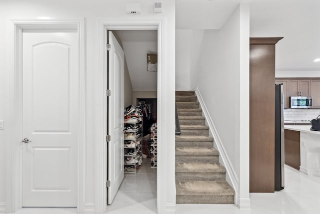 stairs featuring tile patterned floors