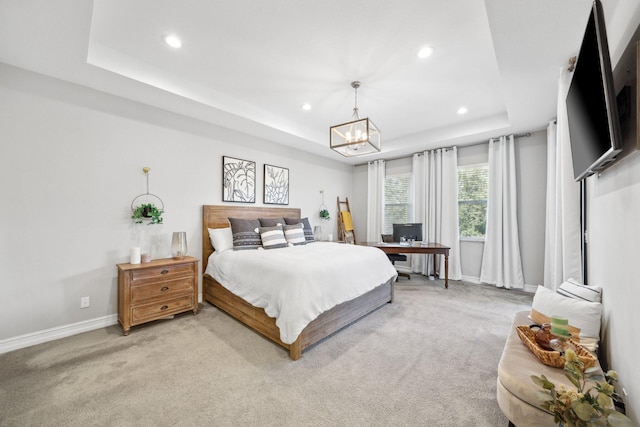 bedroom with a raised ceiling, light carpet, and a notable chandelier