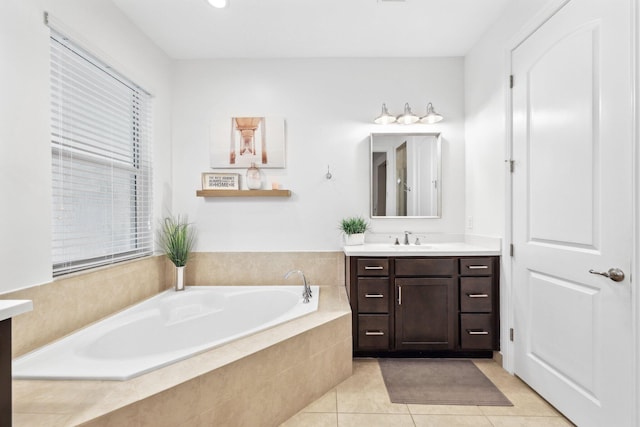 bathroom featuring vanity, tiled bath, and tile patterned floors