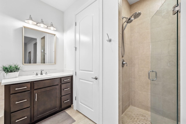 bathroom featuring a shower with door, vanity, and tile patterned flooring