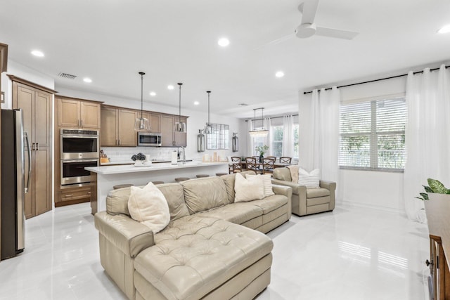 living room with ceiling fan and sink