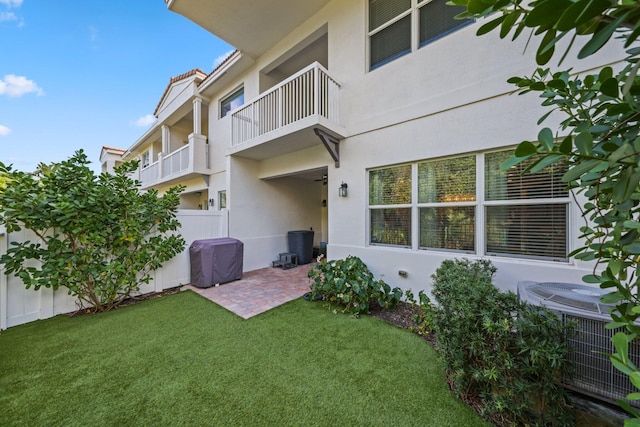 back of house featuring a patio, central air condition unit, and a lawn