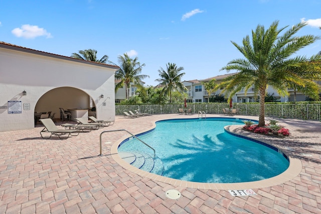 view of swimming pool with a patio area