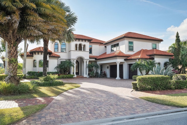 mediterranean / spanish-style home with a garage