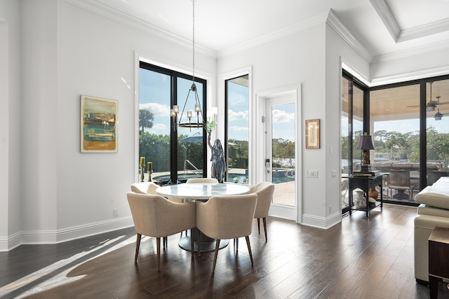 dining space featuring crown molding, dark hardwood / wood-style flooring, and a notable chandelier