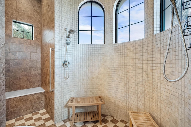 bathroom featuring a healthy amount of sunlight and tiled shower