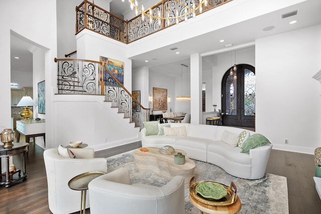 living room with french doors, dark hardwood / wood-style floors, and a high ceiling