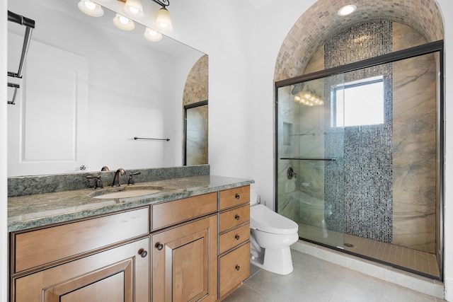 bathroom with walk in shower, vanity, and toilet