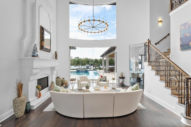 living room with hardwood / wood-style flooring, a high ceiling, and a chandelier