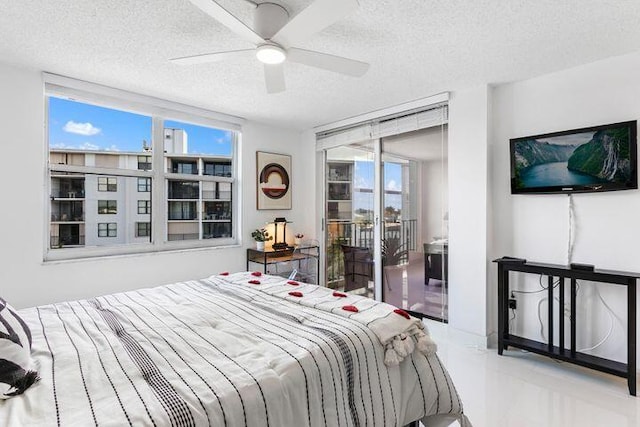 bedroom with a textured ceiling and ceiling fan